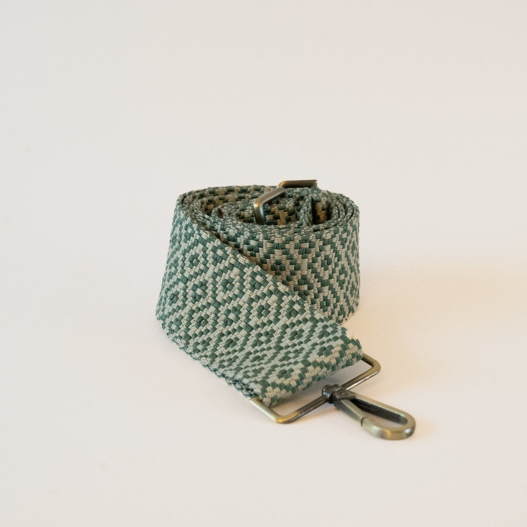 green tapesty crossbody strap with brass hardware